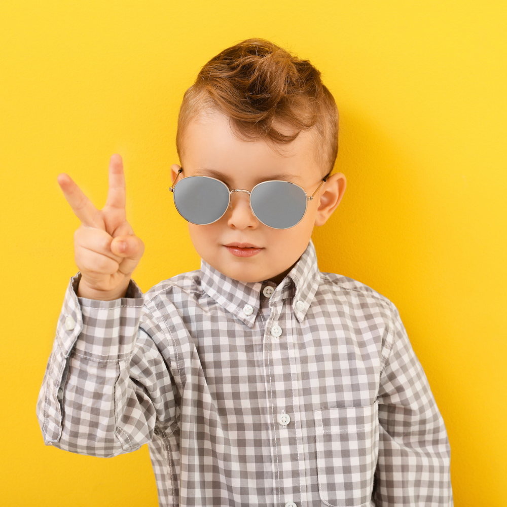 Child patient holding up a peace sign